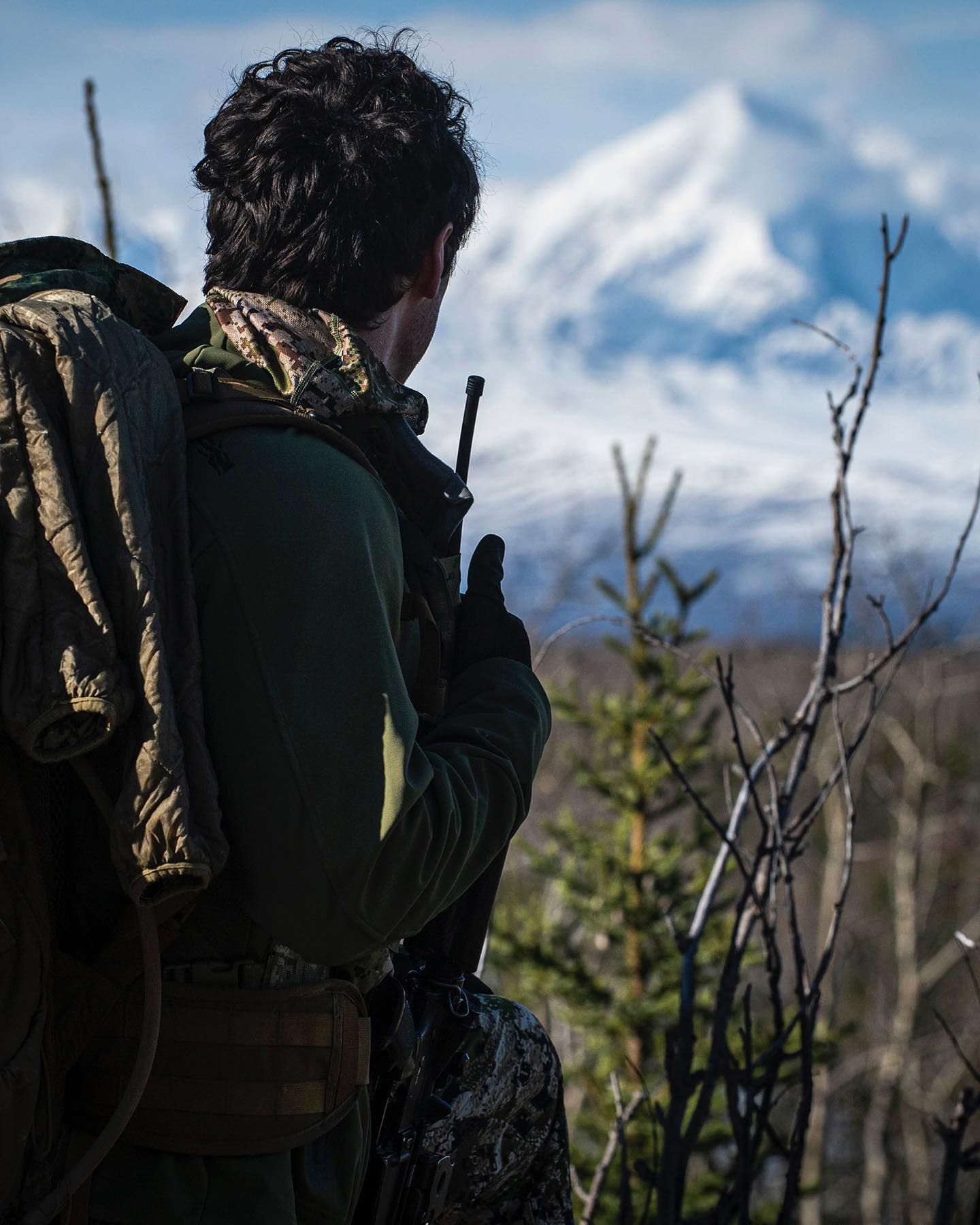 Operator holding overwatch in remote terrain